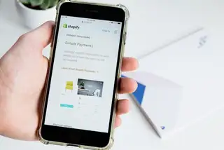 A phone showing a shopify paymen processing page on screen
